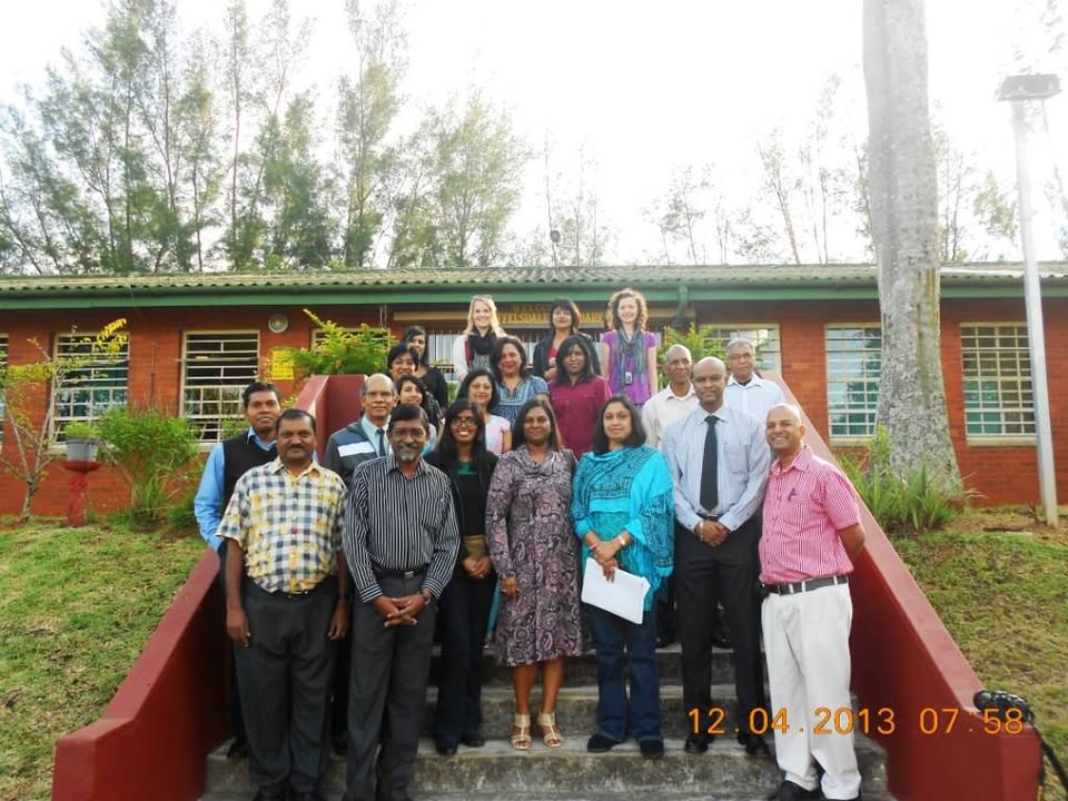 Staff of Buffelsdale Secondary School on the steps of the red-brick school building